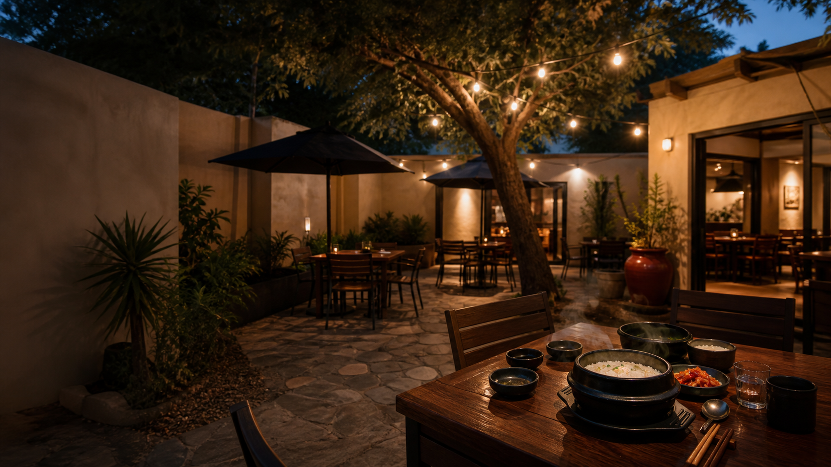 Warm evening table in a tree-lined restaurant courtyard